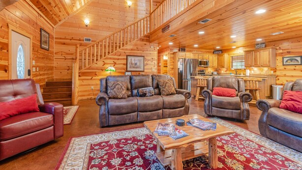 A log cabin interior with a living room, dining area, and kitchen. - Relax by Broken Bow Lake, your cozy 3-bedroom Hochatown retreat (Broken Bow)