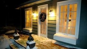 A house with a front porch, two doors, and windows with frosted glass.
