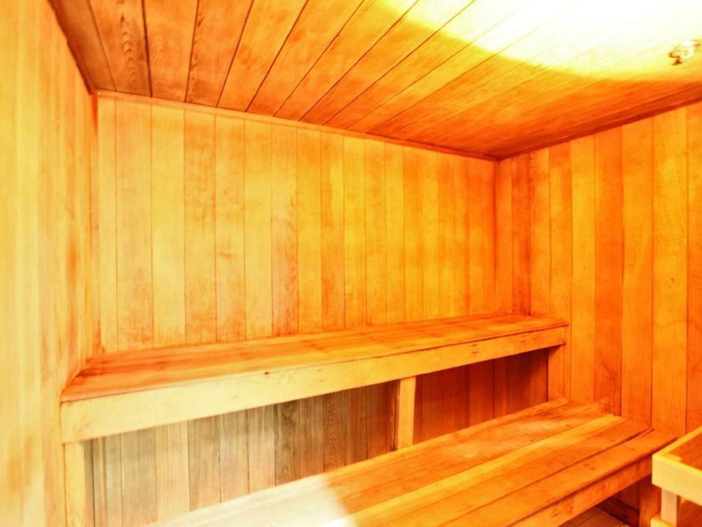 A sauna with wooden walls and benches.
