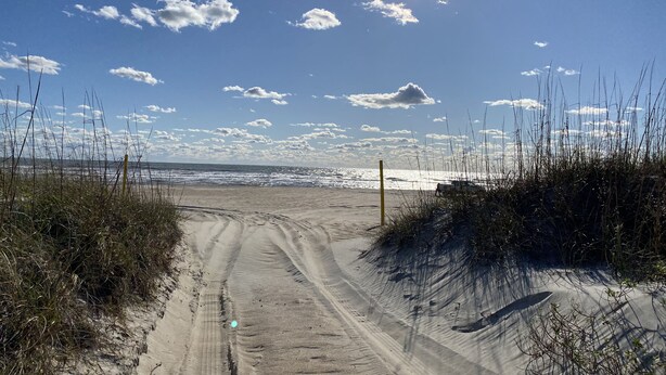 A sandy beach path with sparse vegetation and a clear sky. - Beautiful Retreat with Ocean & Sound Views (Atlantic Beach)