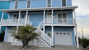 A two-story house with a balcony, a front porch, and a garage. - Beautiful Retreat with Ocean & Sound Views (Atlantic Beach)