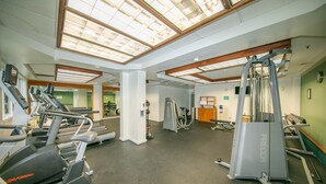A gym with treadmills, ellipticals, and weight machines.