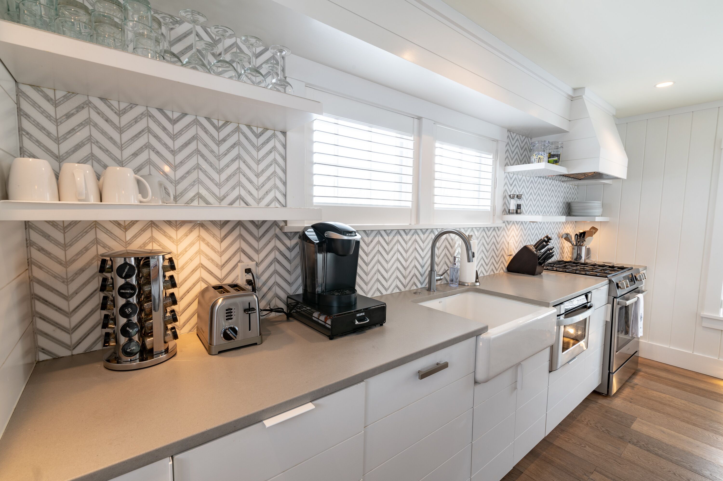 A modern kitchen with a built-in stove, a coffee maker, and a toaster.