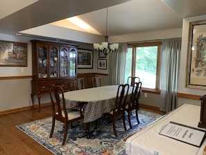 A dining room with a large wooden table, chairs, a patterned rug, a china cabinet, and framed pictures on the walls. - 5 BR, 4 baths, Pool, HotTub, Family Friendly, near Louisville KY, Private (Fredericksburg)