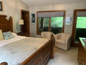 A bedroom with a large bed, two chairs, a nightstand with a lamp, and framed pictures on the wall. - 5 BR, 4 baths, Pool, HotTub, Family Friendly, near Louisville KY, Private (Fredericksburg)