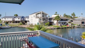 A waterfront property with a dock, a boat, and a view of the water.