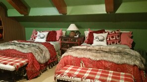 Two beds with red and white bedding, a nightstand with a lamp, and a green wall. - Indian Heaven Treehouse-Nightly Shooting Stars, Miles of Balconies & Rock Views  (Idyllwild)