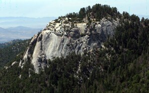 A mountain with a rocky peak and dense forest. - Indian Heaven Treehouse-Nightly Shooting Stars, Miles of Balconies & Rock Views  (Idyllwild)