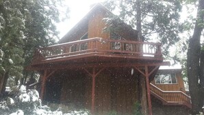 A wooden cabin with a balcony, surrounded by trees and covered in snow. - Indian Heaven Treehouse-Nightly Shooting Stars, Miles of Balconies & Rock Views  (Idyllwild)