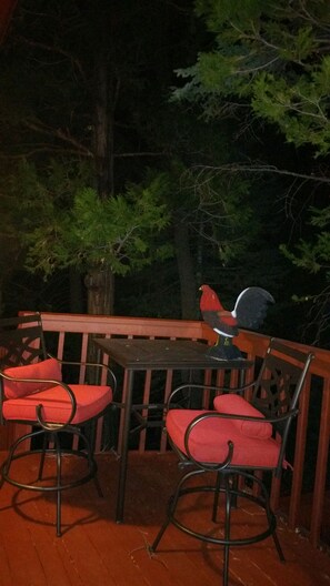 A wooden deck with red cushioned chairs and a table. - Indian Heaven Treehouse-Nightly Shooting Stars, Miles of Balconies & Rock Views  (Idyllwild)