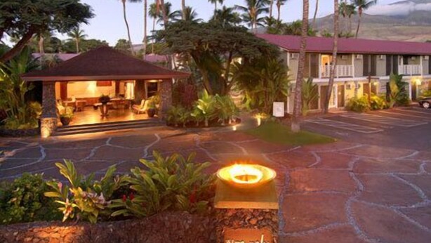 A hotel with a covered outdoor seating area, palm trees, and a stone pathway. - Aina Nalu Studio, Great Rates & Location, AC & WIFI,  2 Pools & Jacuzzi (Lahaina)