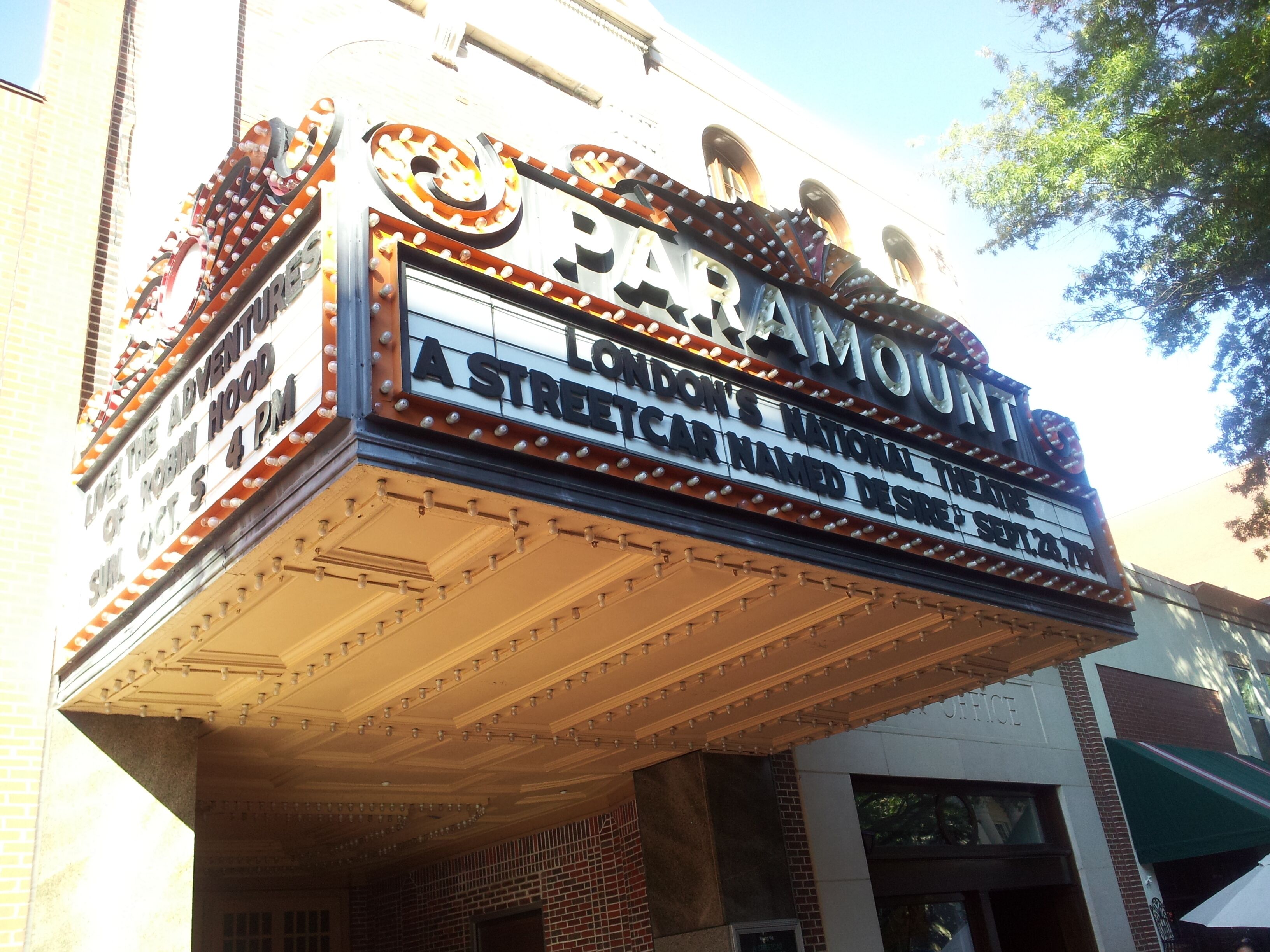 A theater marquee with the name "Paramount" and a sign for "London's National Car Named Desire" playing at 4 PM on Oct 5.
