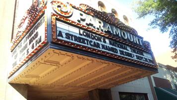 A theater marquee with the name "Paramount" and a sign for "London's National Car Named Desire" playing at 4 PM on Oct 5.