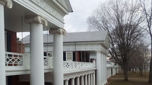 A building with a series of white columns and a covered walkway. - Well Appointed Home For Your Family's Enjoyment In The Heart of Charlottesville (Charlottesville)