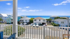 A coastal residential area with houses, a clear blue sky, and a view of the ocean. - The  Kure . (Kure Beach)