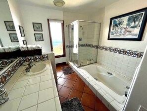 Bathtub, hair dryer, towels, shampoo
