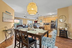 A spacious kitchen with wooden cabinets, a large island, and modern appliances.