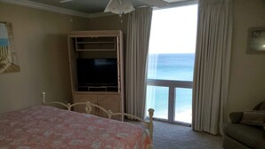 A bedroom with a bed, a television, a wardrobe, and a view of the ocean. - Amazing Beachfront Destin Condo With Ocean Views from All Rooms (Destin)