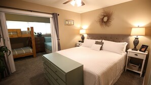 A bedroom with a bed, a dresser, a nightstand, a ceiling fan, and a window with curtains. - Don't Click Here UNLESS You Want The Best Value In Southern Utah! (St George)