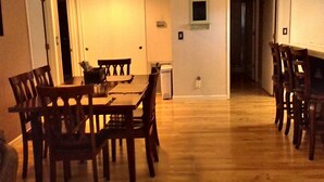 A spacious dining area with a wooden table and chairs, a white door, and a small window. - ***Perfect Walking Distance Location To Downtown Murphy's*** (Murphys)
