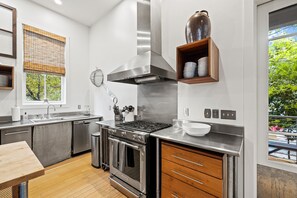 Enjoy cooking in this kitchen with a stove, oven, and dishwasher, and take in the view from the large window.