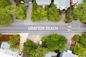 Grayton Beach street lined with lush trees and residential buildings.