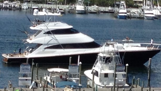 A marina with several yachts docked, surrounded by buildings and palm trees. - DESTIN HARBORWALK, 3 bedrooms w/ Boatdock (destin)