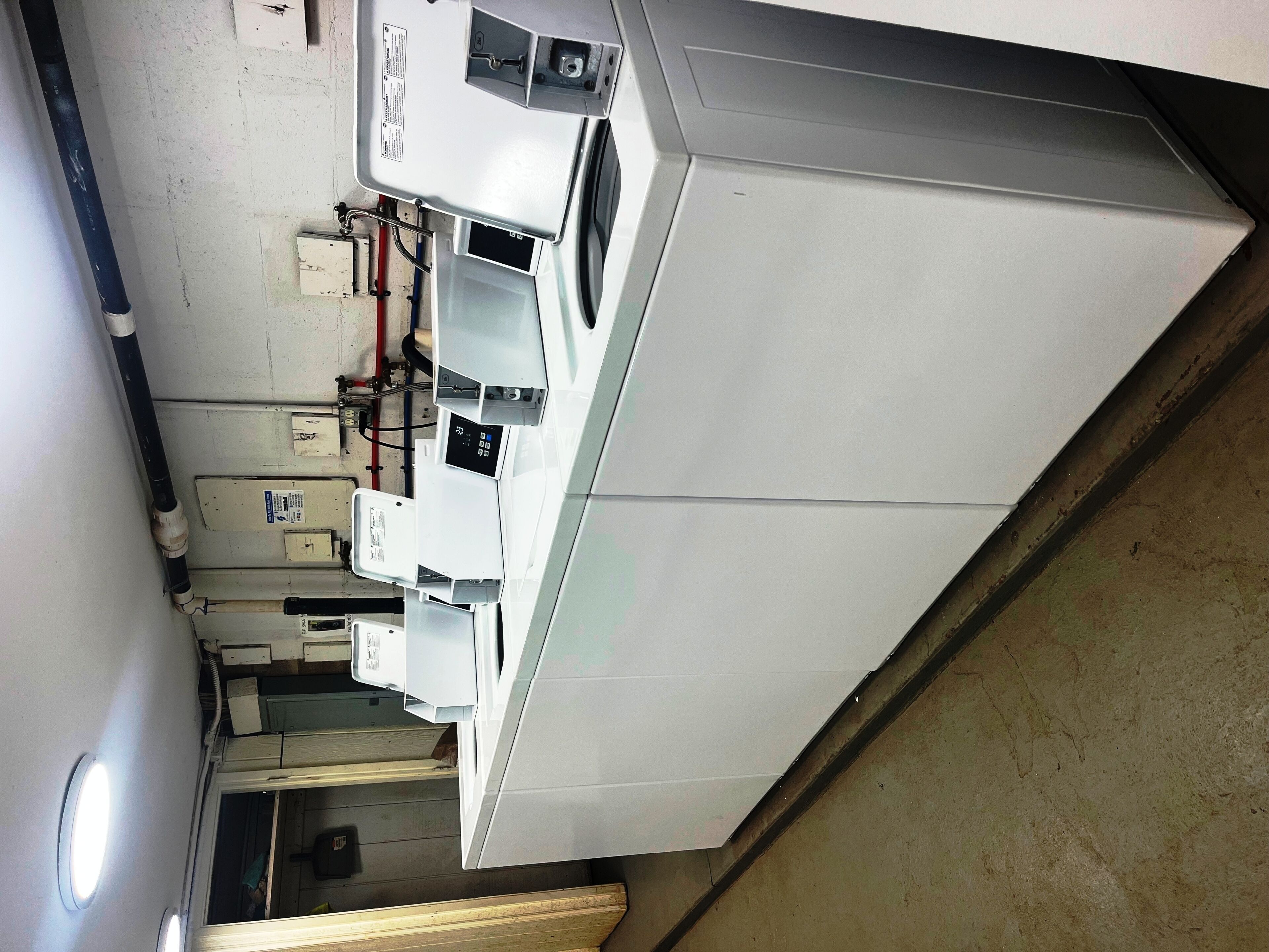 A kitchen with white cabinets, a microwave, and a sink.