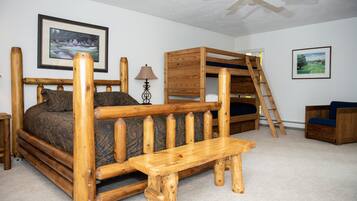Cozy retreat with a bunk bed, wooden bench, and small table.