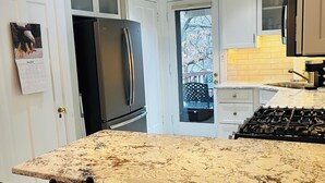 A kitchen with a large island, stainless steel appliances, and pendant lighting. - 
Luxe  Fully Furnished 5 Star Home in Hyde Park/ Cincinnati (Cincinnati)