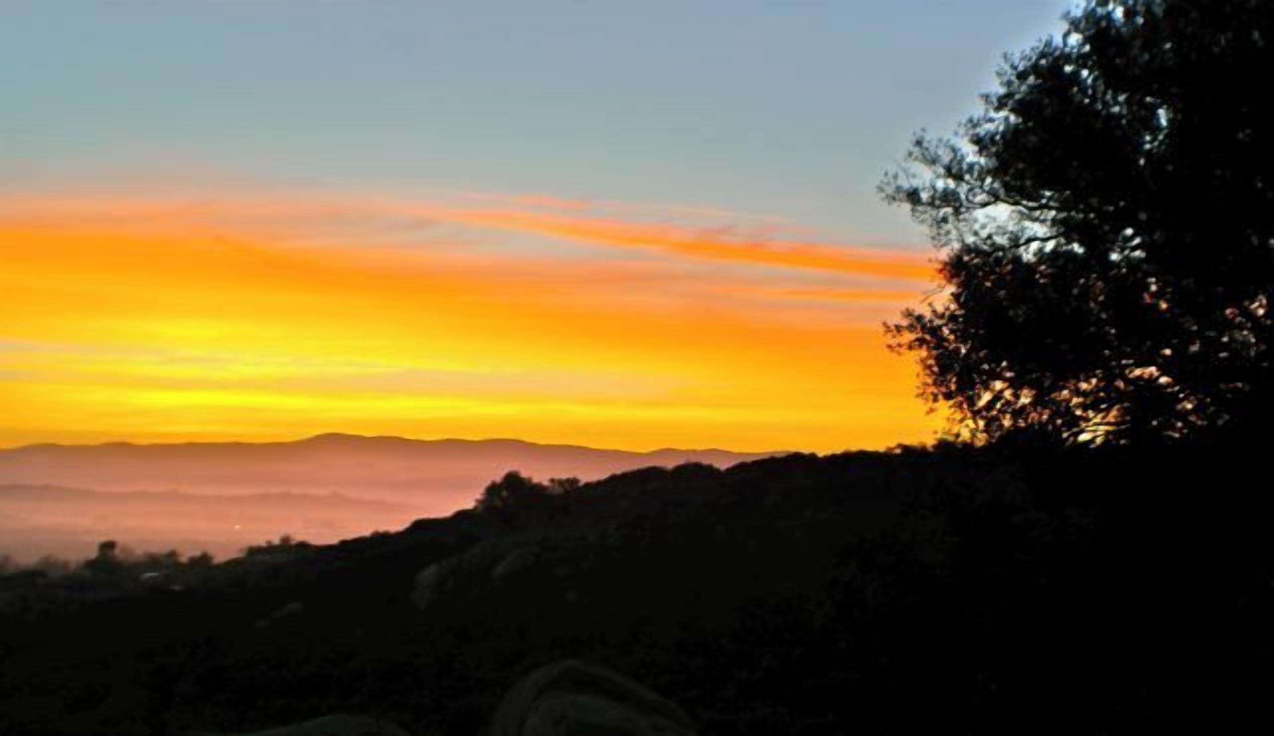 A sunset over a mountainous landscape with a timestamp indicating 21.06.2014.