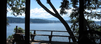 Oceanfront log cabin with sweeping ocean, mountain and sunset vistas