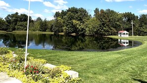 A serene lakeside setting with a gazebo, lush greenery, and a clear sky. - Glenn Acres Farm, Fishing and Relaxing, a Place Everyone Loves! (Columbia)