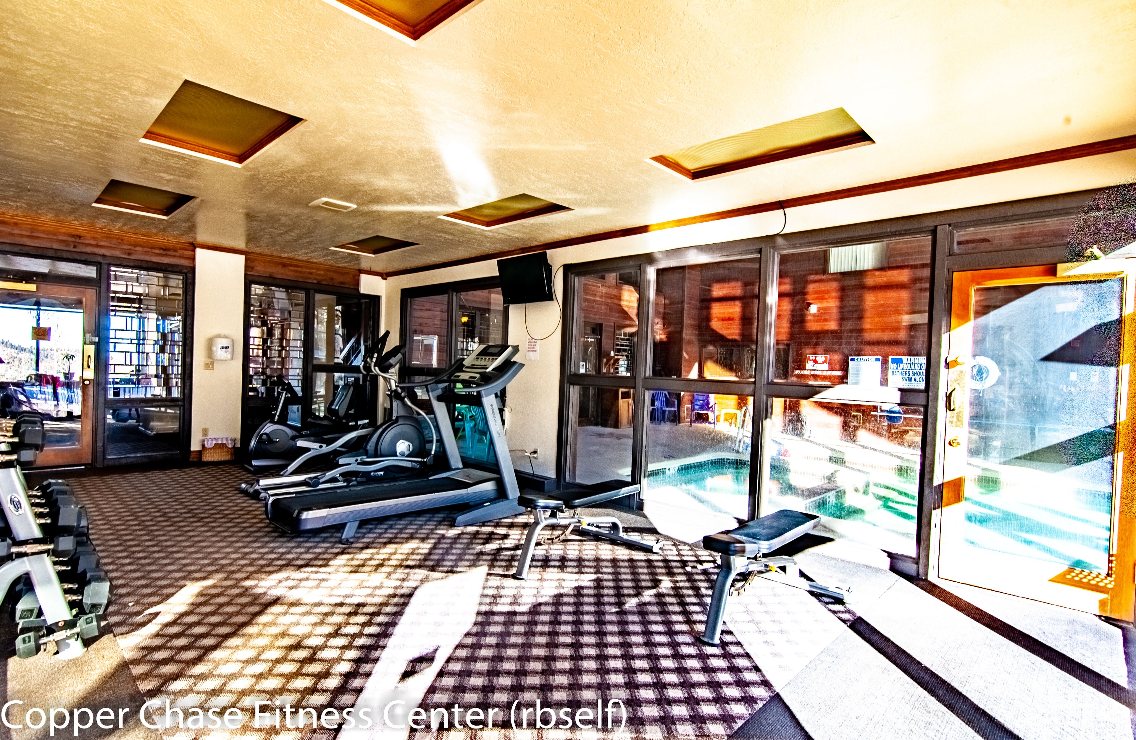 A gym with treadmills, stationary bikes, and exercise equipment.