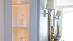 A white cabinet with glass doors displaying decorative items. - Modern Farmhouse in Historic Downtown Bozeman (Bozeman)