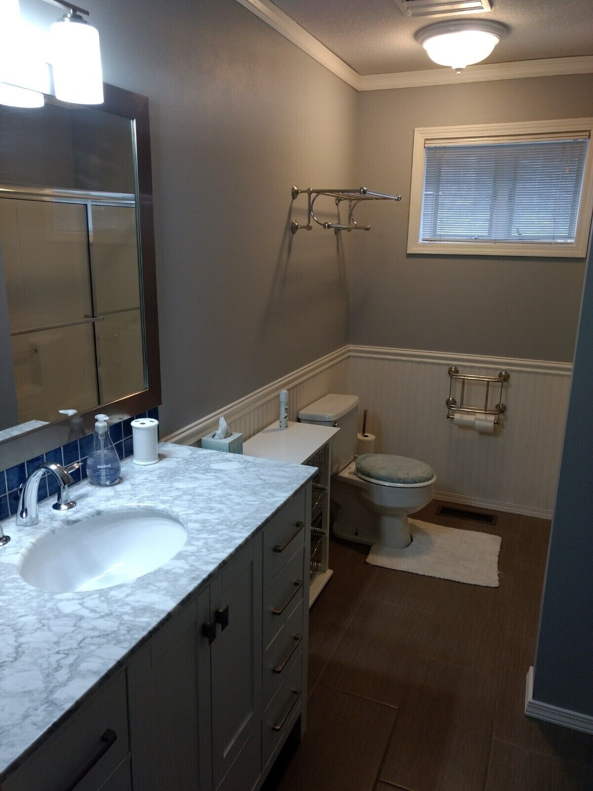 A bathroom with a sink, toilet, and shower.