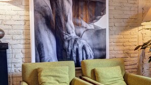 A room with a large abstract painting on the wall, two green armchairs, a wooden coffee table, and a lamp. - CHARMING HIDEAWAY IN FLORENCE OLD TOWN (Firenze)