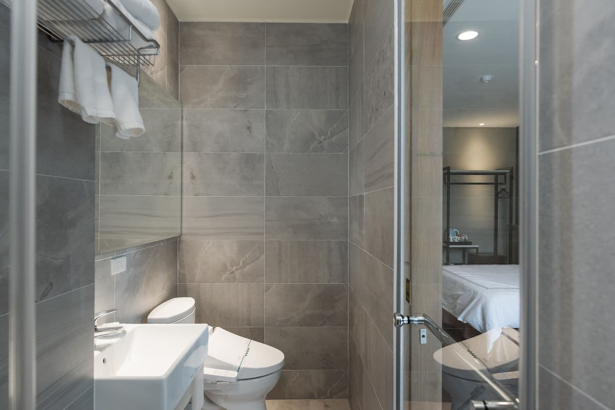 standard quadruple room | bathroom | deep-soaking bathtub, rainfall showerhead, free toiletries, hair dryer
