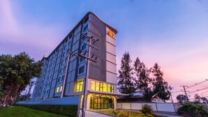 A modern hotel with a prominent 'B2' sign, large windows, and a well-lit entrance. - B2 Ubon Premier Hotel (Ubon Ratchathani)