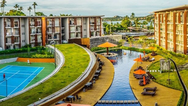 A hotel with multiple floors, a swimming pool, and a tennis court. - Condo Studio B at Replay E305 (Koh Samui)