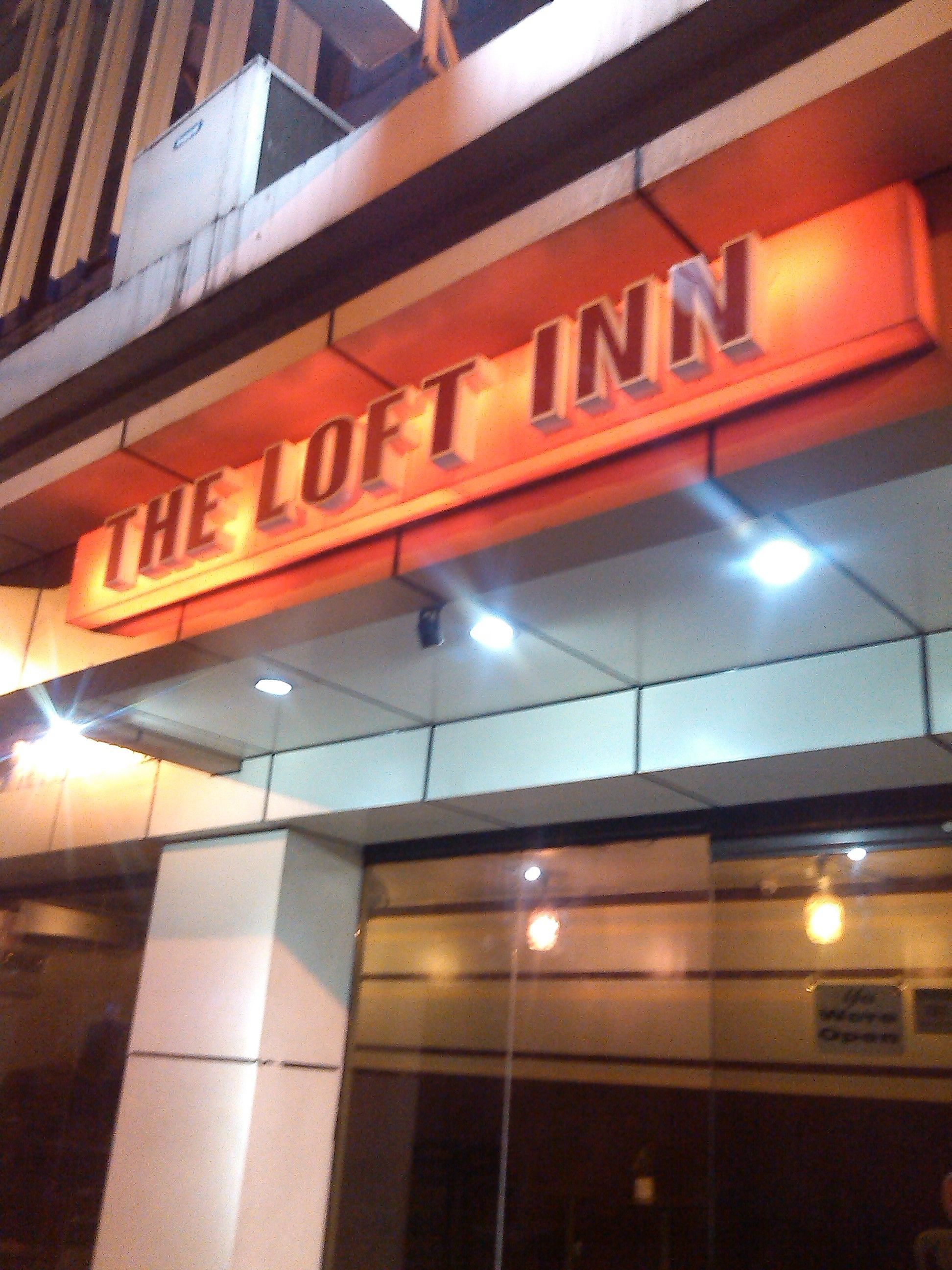 A sign for "The Loft Inn" with a modern design and illuminated lettering.