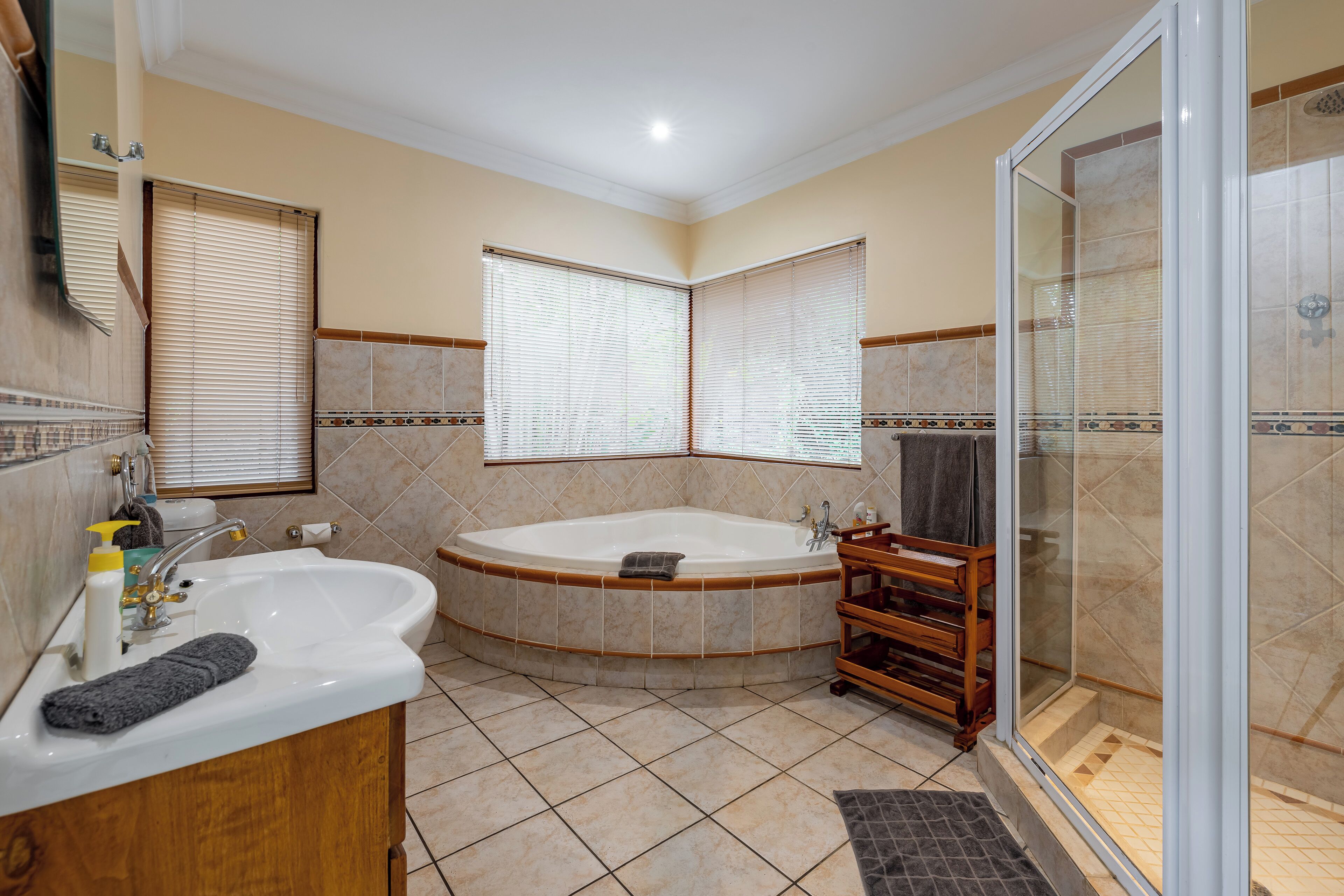 A bathroom with a bathtub, a shower, and a sink.