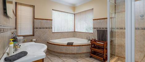 A bathroom with a bathtub, a shower, and a sink.