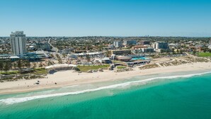 An aerial view of a coastal city with a beach, a stadium, and various buildings. - Ramada VetroBlu Scarborough Beach (Scarborough)