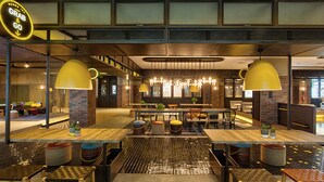 A modern indoor space with a central dining area, multiple seating arrangements, and a prominent 'Grab & Go' sign. - Rooms Inc Semarang (Semarang)