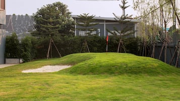 Stroll through the serene landscaped garden, surrounded by lush greenery and a picturesque flagpole.