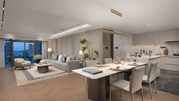 A modern apartment with a dining area, kitchen, and living room.