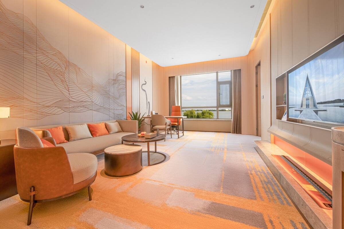 A modern living room with a sofa, coffee table, and TV.