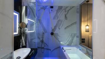 Ein modernes Badezimmer mit einer gläsernen Duschkabine, einem Standwaschbecken und einer freistehenden Badewanne.