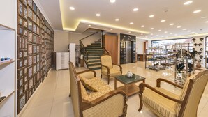 A well-lit interior with a staircase, seating area, and a jewelry display. - Magnaura House Hotel (Istanbul)